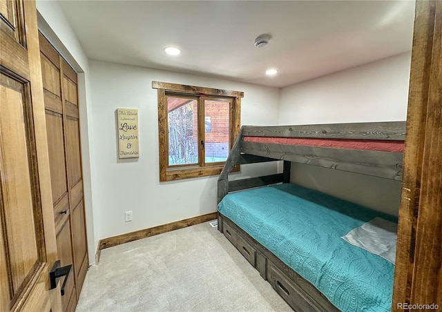 bedroom with light carpet and a closet