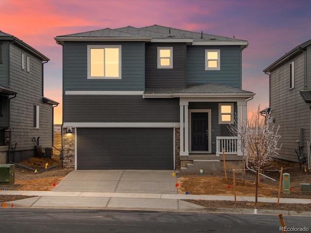 view of front of house with a garage and cooling unit