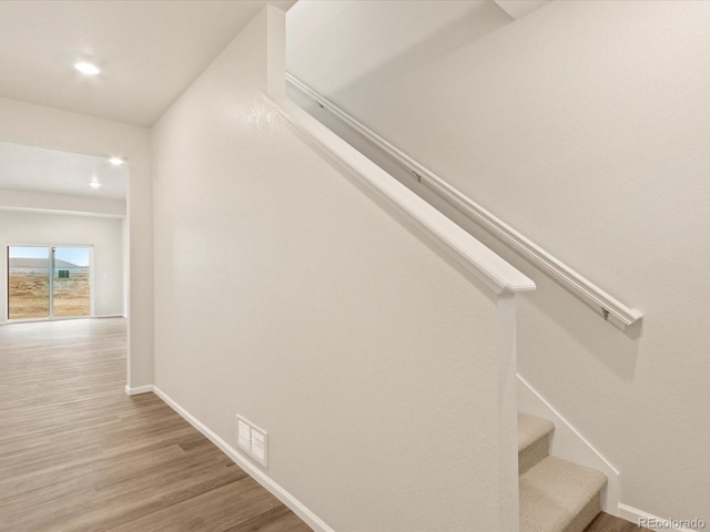 staircase featuring wood-type flooring