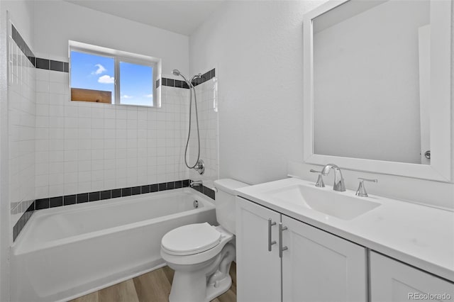 full bathroom with wood-type flooring, vanity, toilet, and tiled shower / bath combo