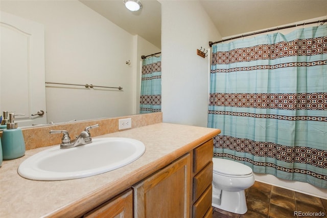 bathroom with vanity, toilet, and curtained shower