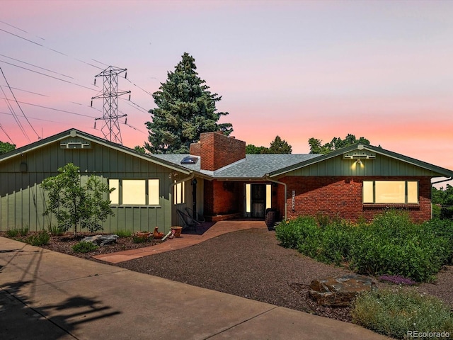 10400 W 35th Pl, Wheat Ridge, CO 80033 - ranch-style home featuring brick siding, a chimney, and board and batten siding