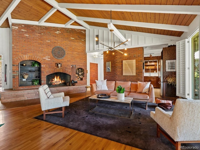 10400 W 35th Pl, Wheat Ridge, CO 80033 - living area with brick wall, a fireplace, wood finished floors, a wooden ceiling with exposed beams, and a chandelier