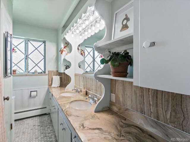 10400 W 35th Pl, Wheat Ridge, CO 80033 - bathroom featuring a baseboard radiator, double vanity, and wainscoting