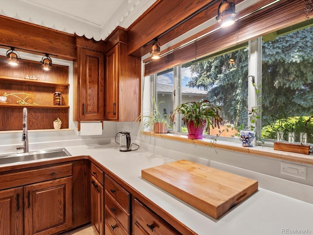 10400 W 35th Pl, Wheat Ridge, CO 80033 - kitchen with light countertops, brown cabinetry, and crown molding