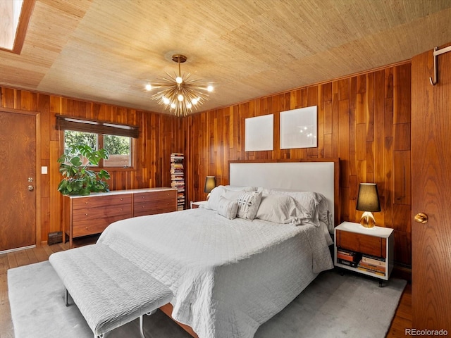 10400 W 35th Pl, Wheat Ridge, CO 80033 - bedroom with wood ceiling, a chandelier, wooden walls, and wood finished floors