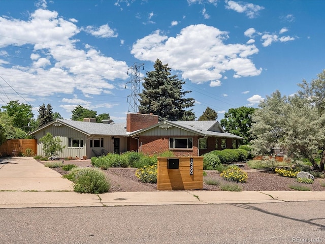10400 W 35th Pl, Wheat Ridge, CO 80033 - single story home with concrete driveway, brick siding, and board and batten siding