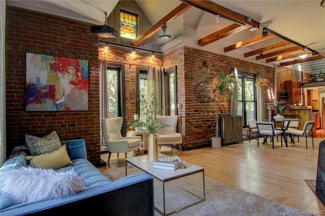 3259 W Hayward Pl, Denver, CO 80211 - living room featuring brick wall, rail lighting, high vaulted ceiling, wood finished floors, and beam ceiling