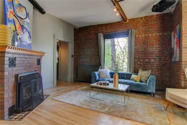 3259 W Hayward Pl, Denver, CO 80211 - living room with wood finished floors, rail lighting, and brick wall