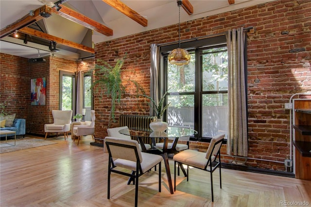 3259 W Hayward Pl, Denver, CO 80211 - dining area with beam ceiling, high vaulted ceiling, and brick wall