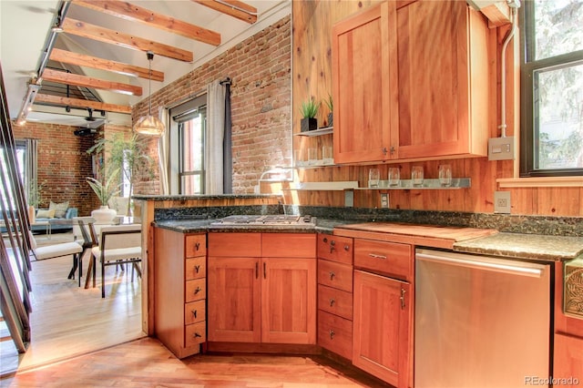 3259 W Hayward Pl, Denver, CO 80211 - kitchen featuring brick wall, plenty of natural light, light wood-style floors, appliances with stainless steel finishes, and a peninsula
