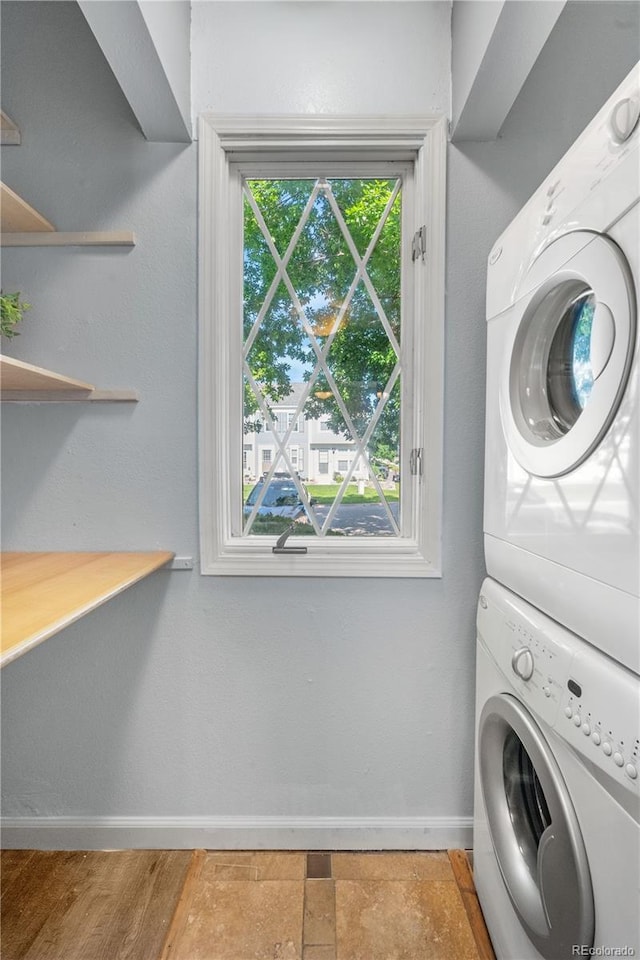 10819 Summerset Way, Parker, CO 80138 - laundry area featuring stacked washer and clothes dryer and baseboards