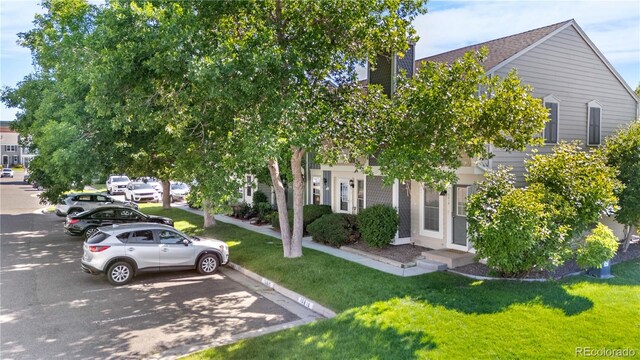 10819 Summerset Way, Parker, CO 80138 - view of property hidden behind natural elements featuring uncovered parking and a front yard