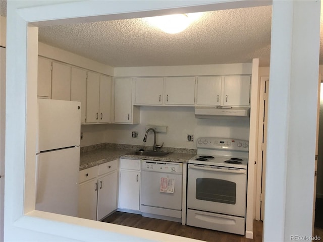 kitchen with white appliances, a sink, a textured ceiling, white cabinetry, and exhaust hood