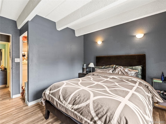100 S Clarkson St Unit 202, Denver, CO 80209 - bedroom with light wood-style flooring, a textured wall, and a textured ceiling