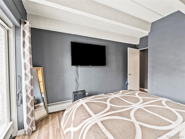 100 S Clarkson St Unit 202, Denver, CO 80209 - bedroom featuring wood finished floors and a textured ceiling