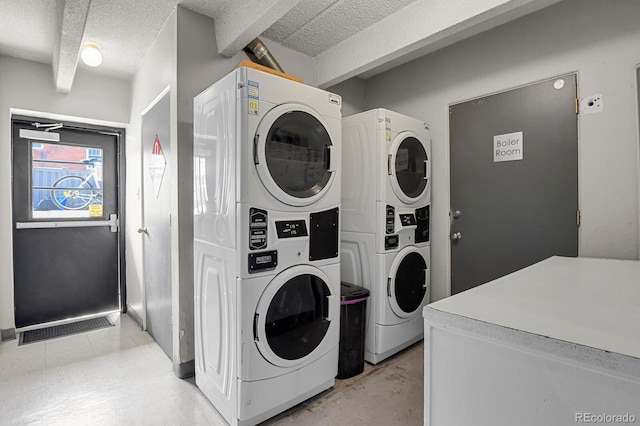 100 S Clarkson St Unit 202, Denver, CO 80209 - laundry room with stacked washer / dryer and a textured ceiling