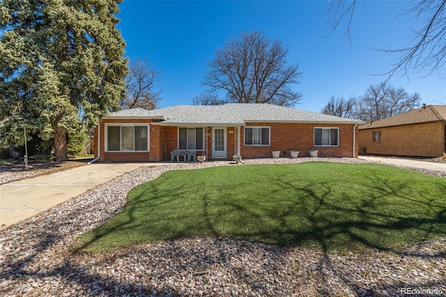 938 Racine St, Aurora, CO 80011 - single story home with brick siding and a front lawn