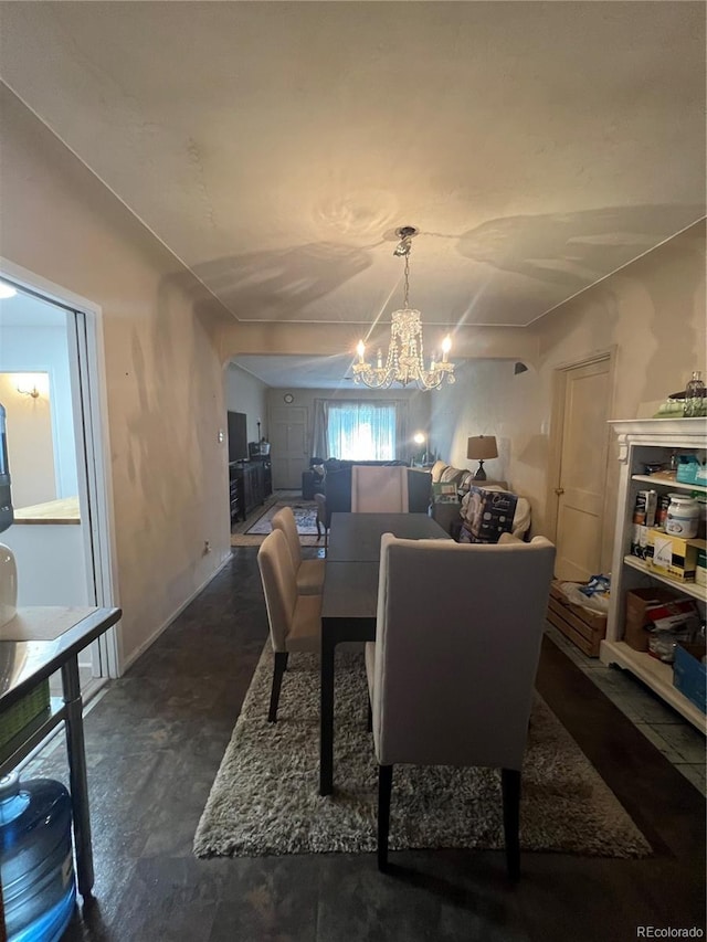 938 Racine St, Aurora, CO 80011 - dining room featuring a chandelier and finished concrete floors