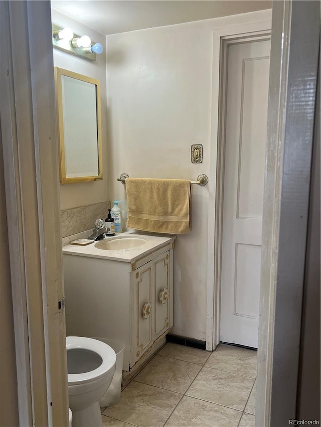 938 Racine St, Aurora, CO 80011 - half bathroom featuring vanity and tile patterned floors