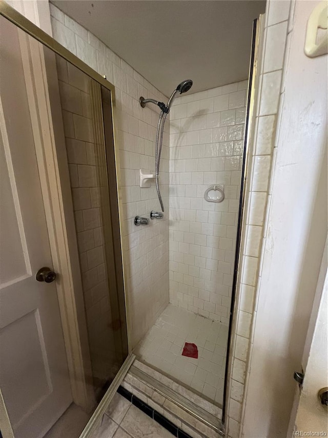 938 Racine St, Aurora, CO 80011 - bathroom featuring a stall shower and tile patterned flooring