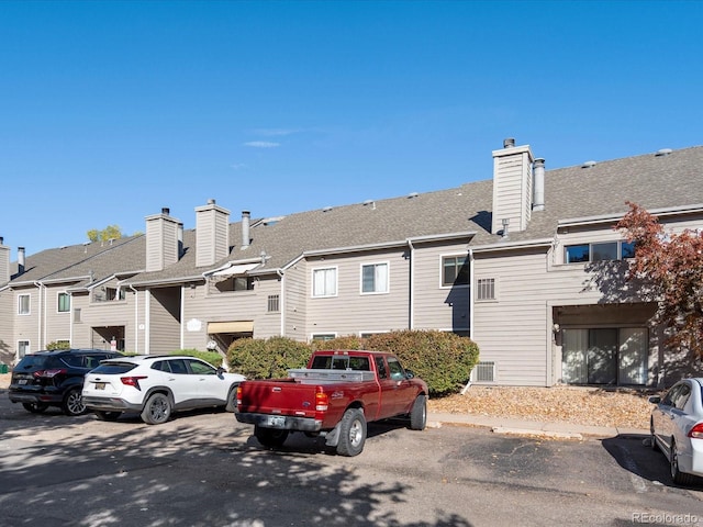 view of front of home with uncovered parking and a residential view