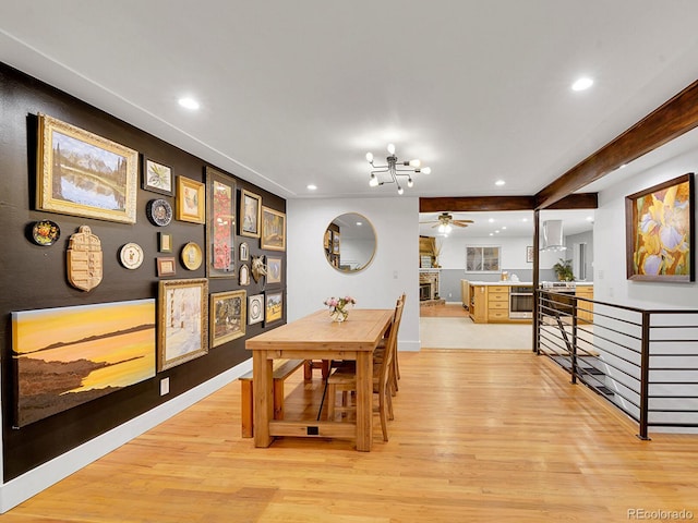 dining room featuring ceiling fan with notable chandelier and light wood-type flooring