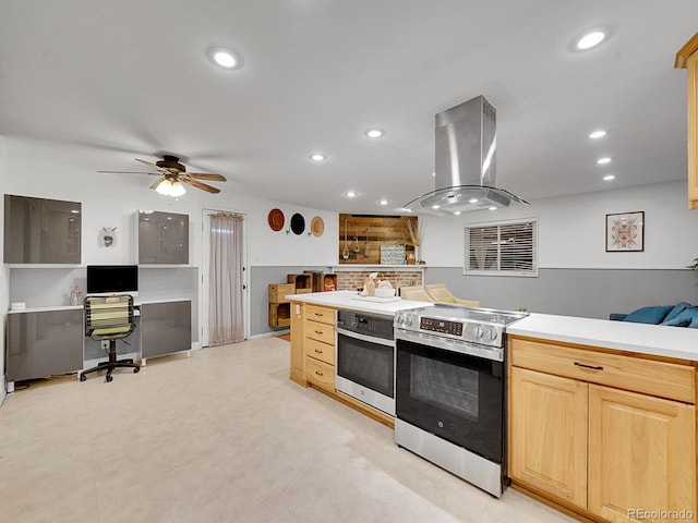 kitchen with ceiling fan, island range hood, light brown cabinets, and appliances with stainless steel finishes