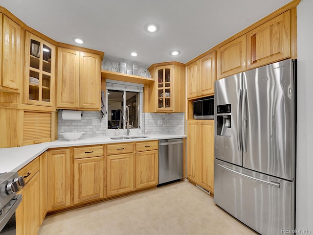 kitchen featuring decorative backsplash, sink, and stainless steel appliances