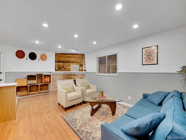 living room with wood walls and light wood-type flooring