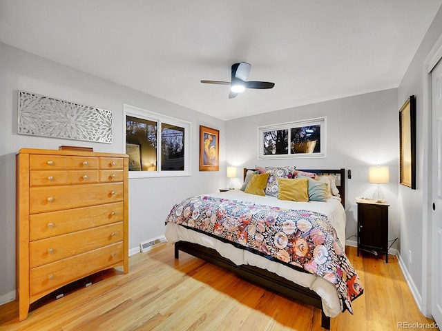 bedroom with light hardwood / wood-style flooring and ceiling fan