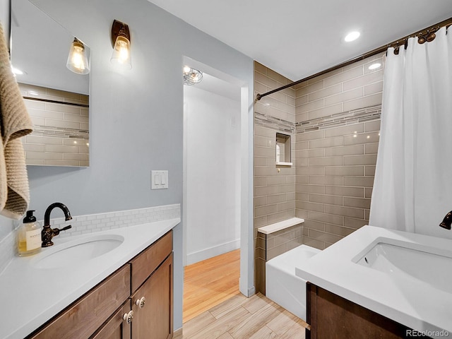 bathroom featuring hardwood / wood-style flooring, vanity, and shower / tub combo with curtain