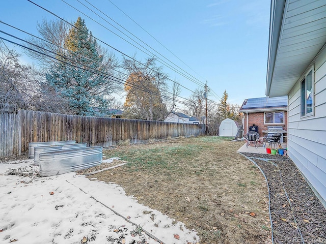 view of yard featuring a shed and a patio