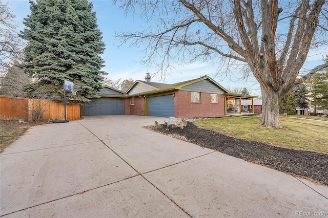 view of front of home with a front yard and a garage