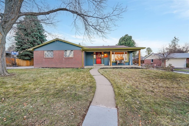 ranch-style home with covered porch and a front lawn