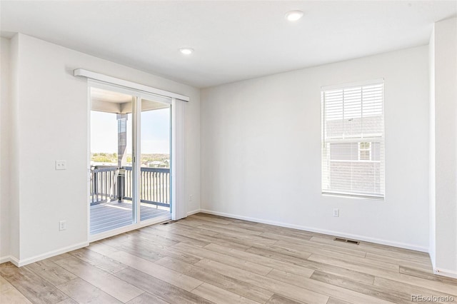 spare room with recessed lighting, baseboards, and light wood finished floors