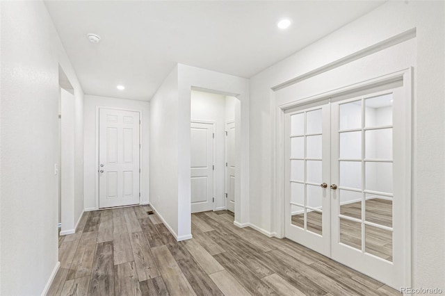 interior space with recessed lighting, baseboards, and wood finished floors