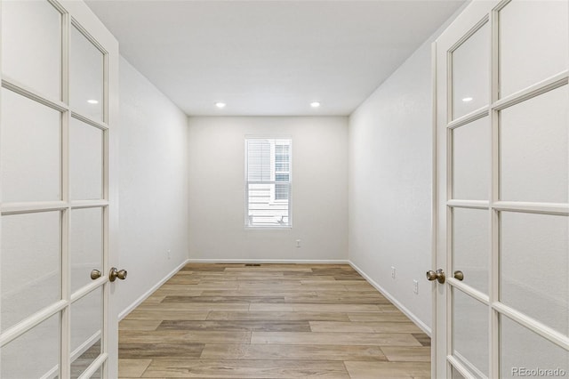 unfurnished room with recessed lighting, baseboards, and light wood-style floors