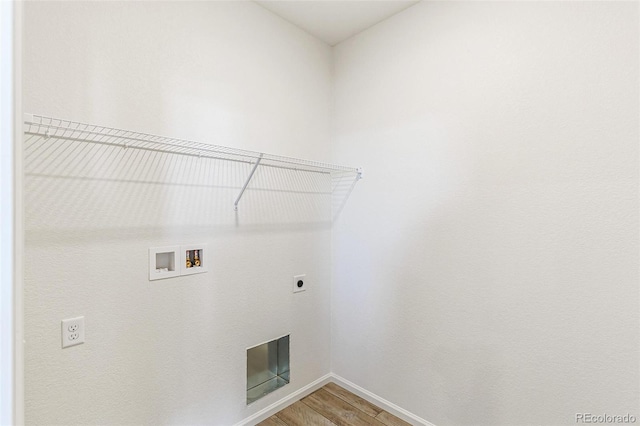 laundry area featuring light wood-type flooring, baseboards, hookup for an electric dryer, hookup for a washing machine, and laundry area