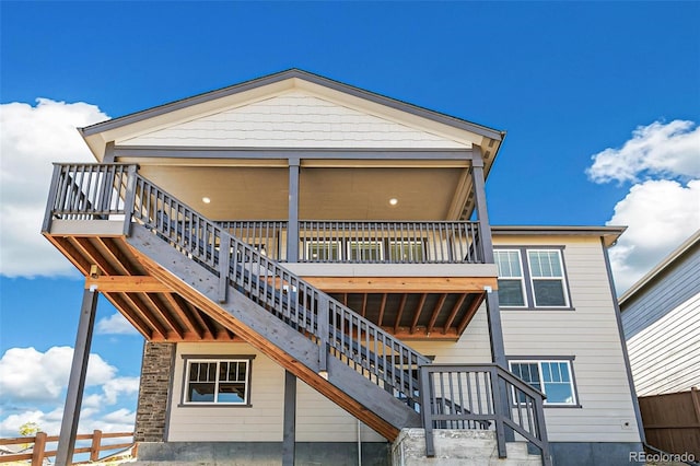 back of property with stairs and fence