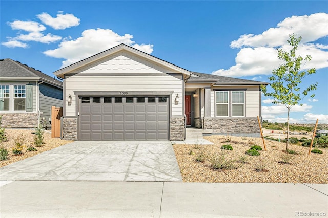 craftsman-style house with stone siding, an attached garage, and concrete driveway