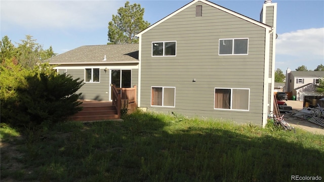 6815 Hills Dr, Parker, CO 80138 - back of property featuring a chimney, a deck, and a lawn
