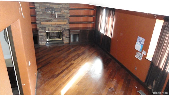 6815 Hills Dr, Parker, CO 80138 - unfurnished living room featuring a stone fireplace and hardwood / wood-style floors