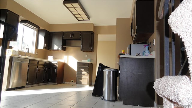 6815 Hills Dr, Parker, CO 80138 - kitchen with dishwasher, a sink, dark brown cabinetry, light tile patterned floors, and light countertops