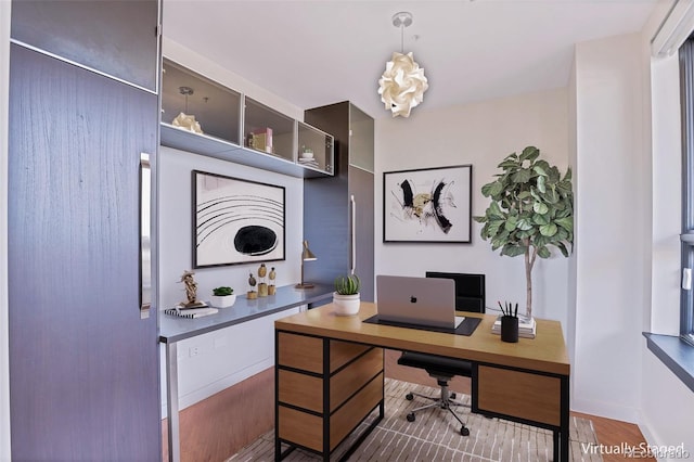 home office with dark hardwood / wood-style flooring