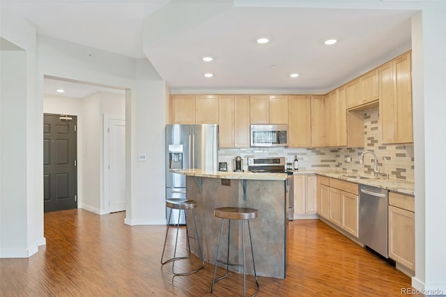 kitchen with sink, light brown cabinetry, tasteful backsplash, and appliances with stainless steel finishes