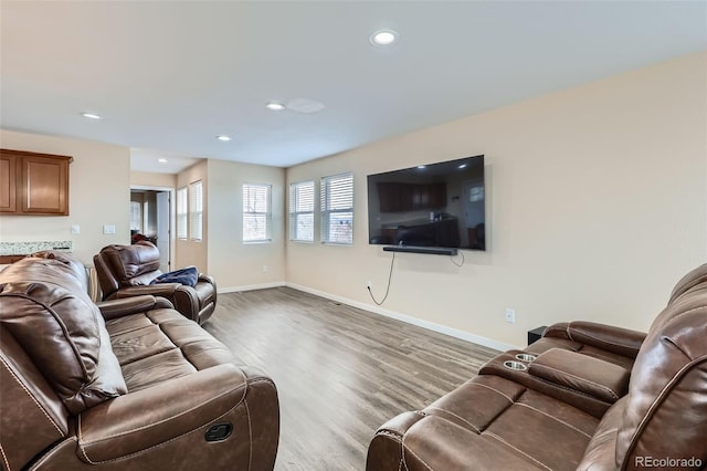 living room with recessed lighting, baseboards, and wood finished floors
