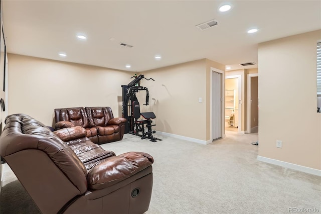 living area with visible vents, recessed lighting, and light colored carpet