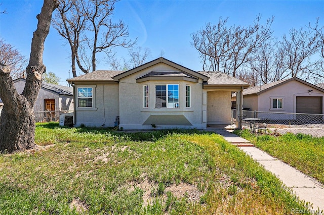 4740 Milwaukee St, Denver, CO 80216 - view of front facade with stucco siding and a garage
