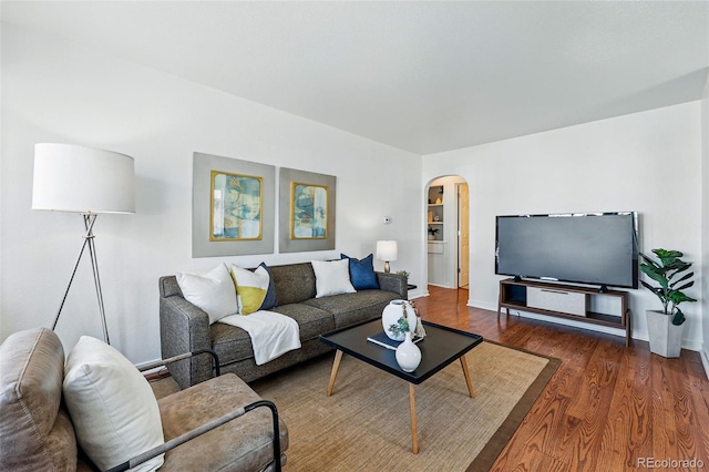 4740 Milwaukee St, Denver, CO 80216 - living room with arched walkways, wood finished floors, and baseboards